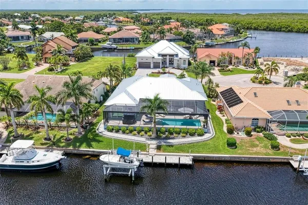 an aerial view of a house with swimming pool patio and outdoor seating