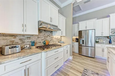 a large white kitchen with a large window