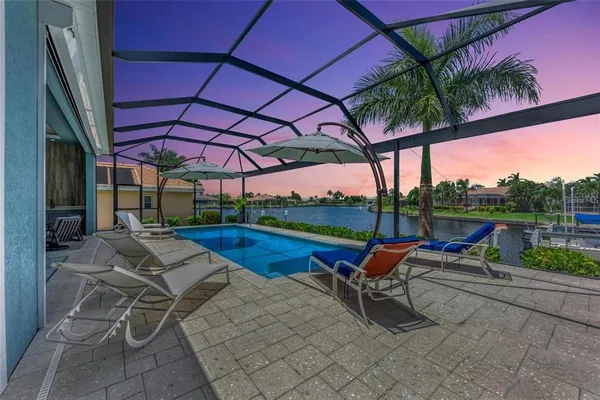 a view of a patio with a table and chairs under an umbrella