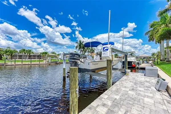 a bedroom with a bed a window and painting on the wall