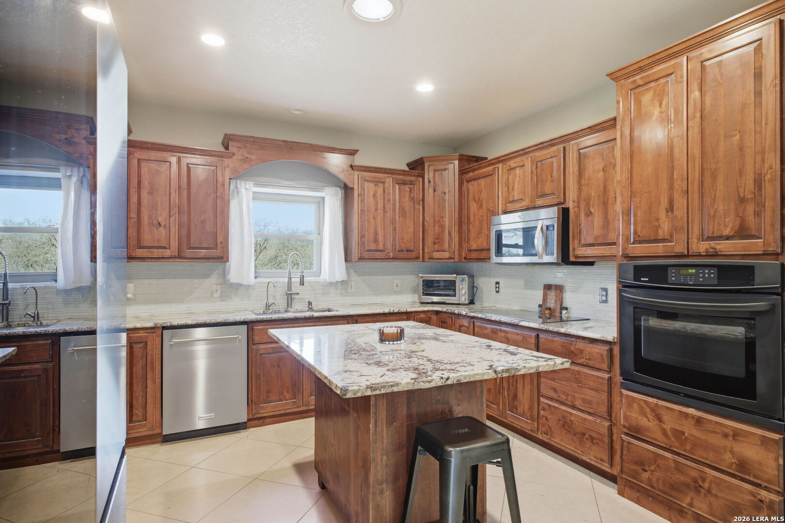 30870 Bridlegate Drive Bulverde, TX 78163 - Photo 18 of 44 a kitchen with a stove a sink and a microwave
