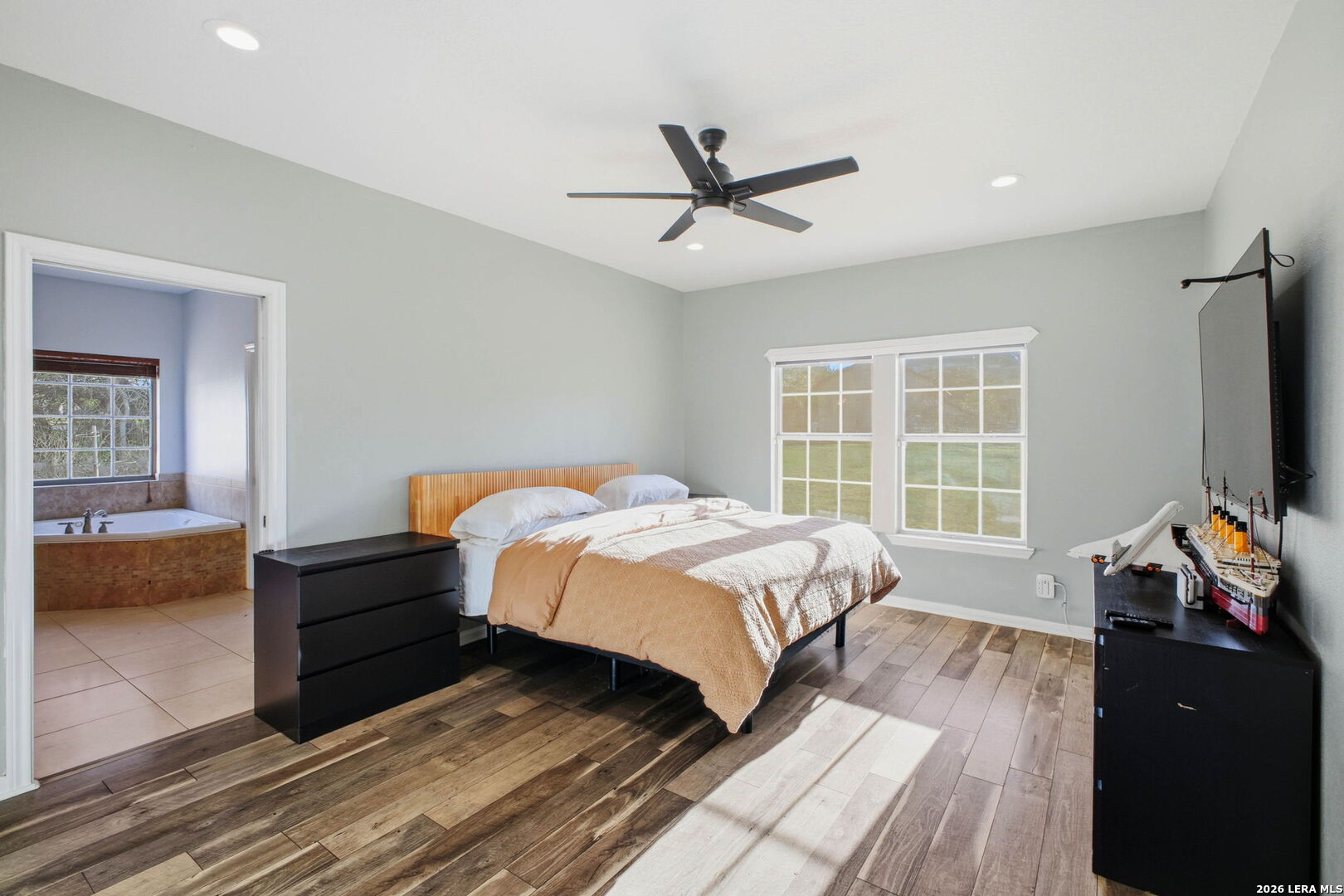 30870 Bridlegate Drive Bulverde, TX 78163 - Photo 20 of 44 a bedroom with a bed and a flat screen tv