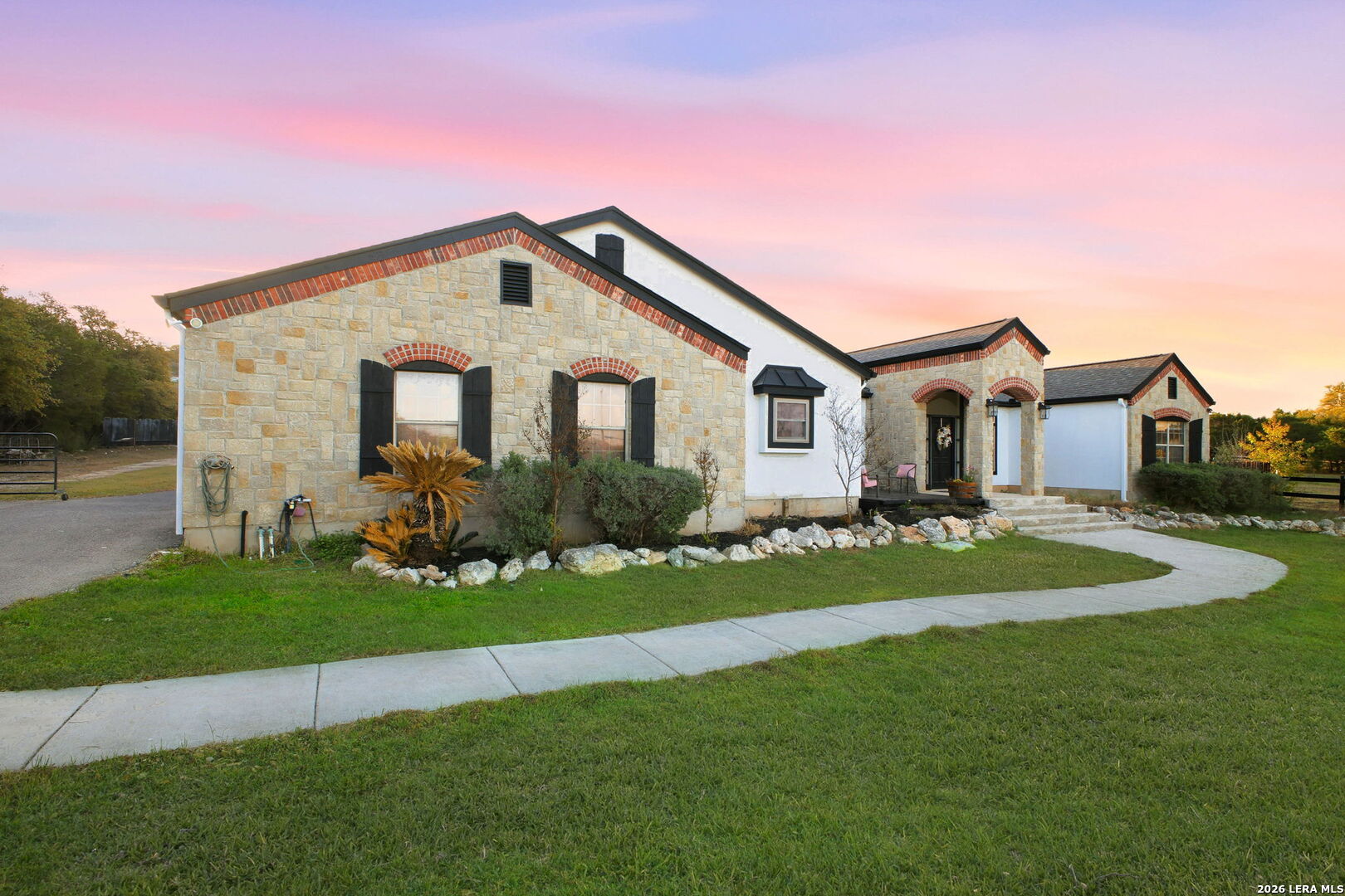 30870 Bridlegate Drive Bulverde, TX 78163 - Photo 2 of 44 a front view of a house with a garden and yard