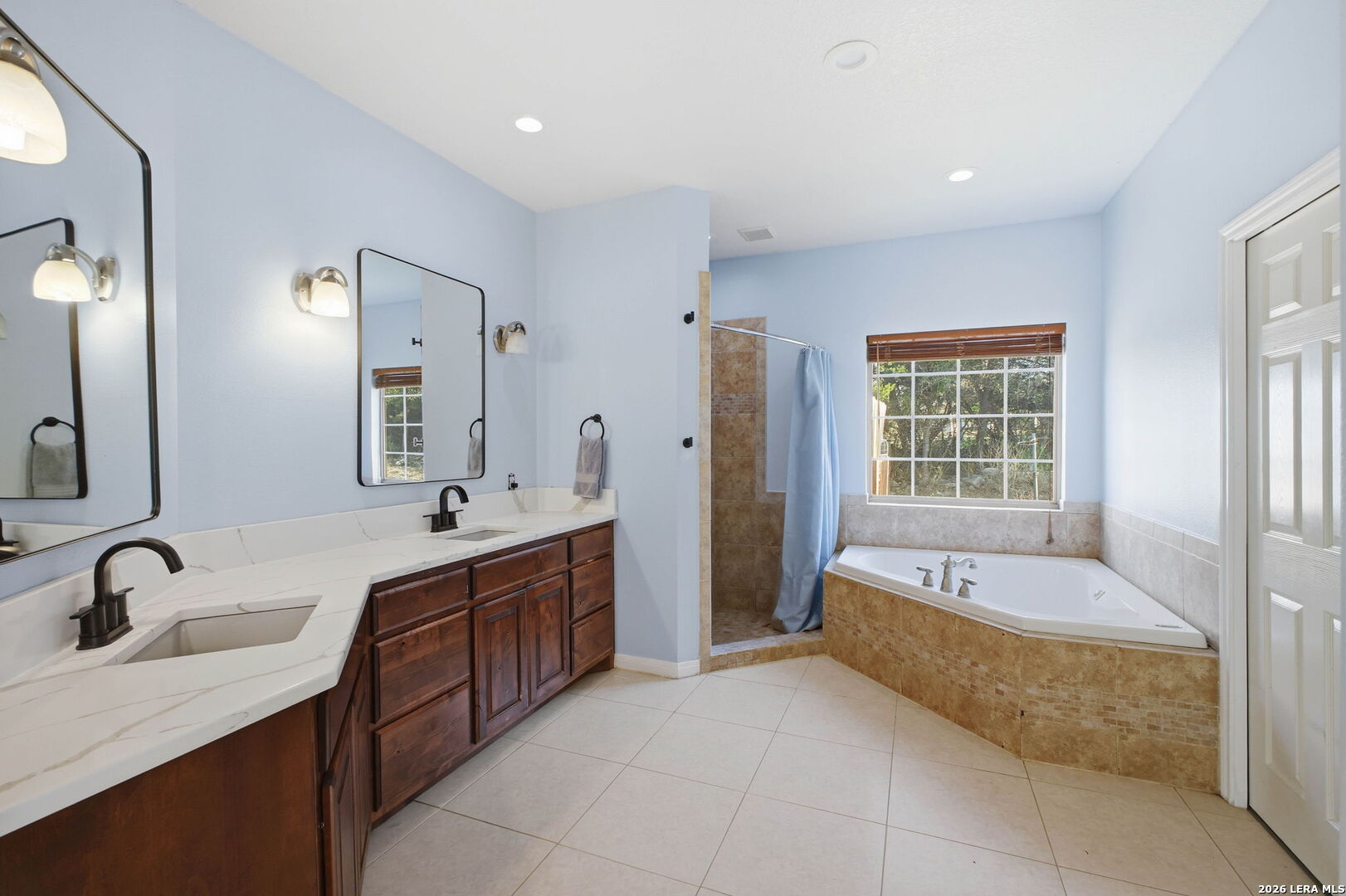 30870 Bridlegate Drive Bulverde, TX 78163 - Photo 21 of 44 a large spacious bathroom with a granite countertop tub sink and mirror
