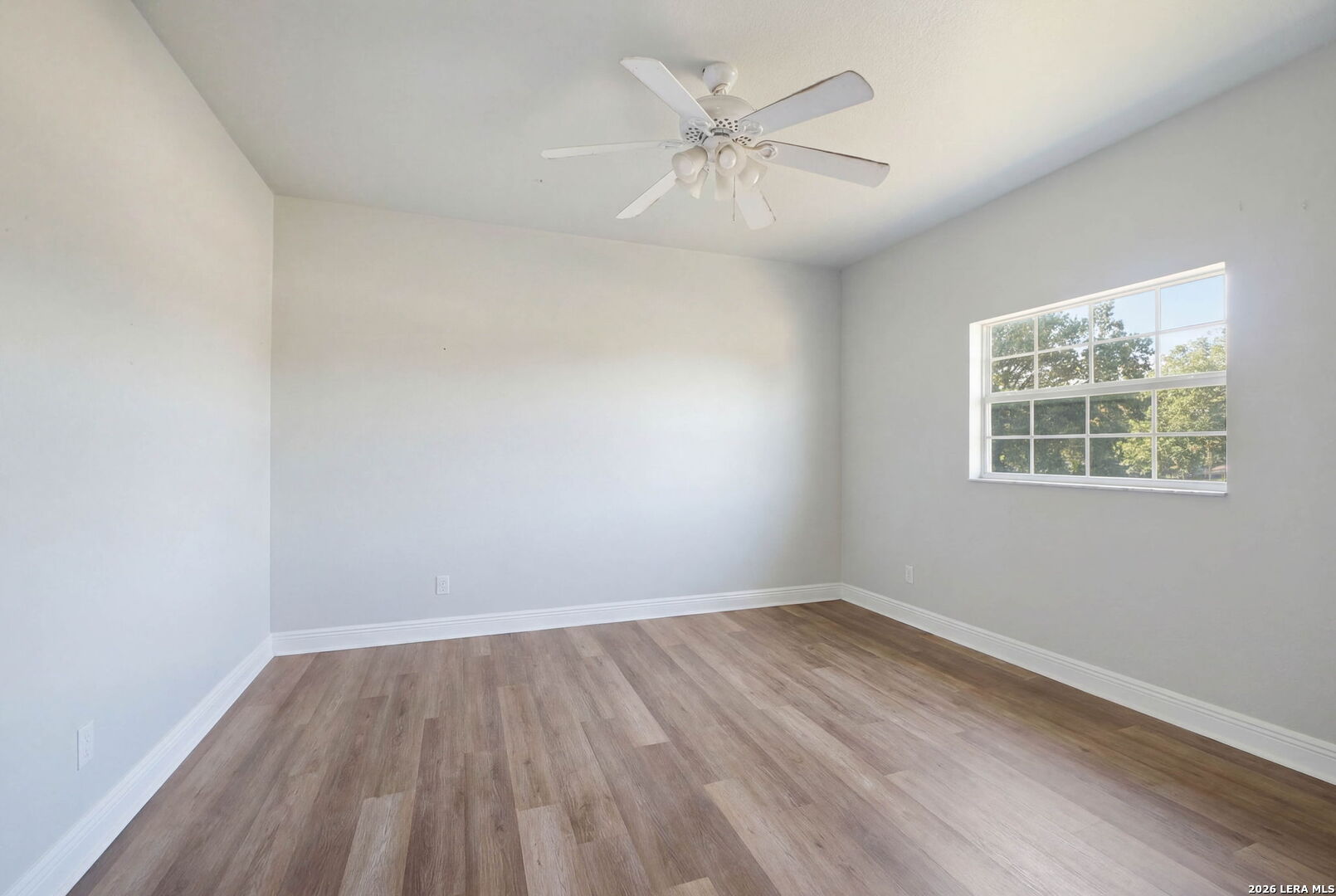 30870 Bridlegate Drive Bulverde, TX 78163 - Photo 25 of 44 an empty room with wooden floor and windows