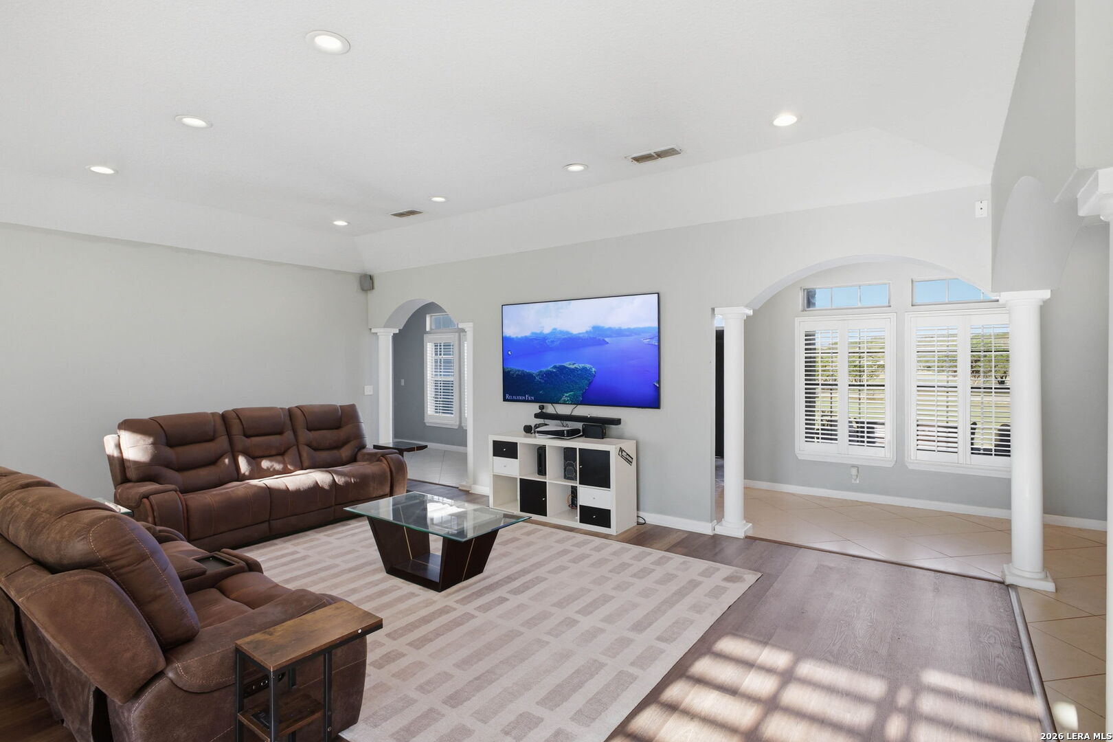 30870 Bridlegate Drive Bulverde, TX 78163 - Photo 10 of 44 a living room with furniture a flat screen tv and floor to ceiling window