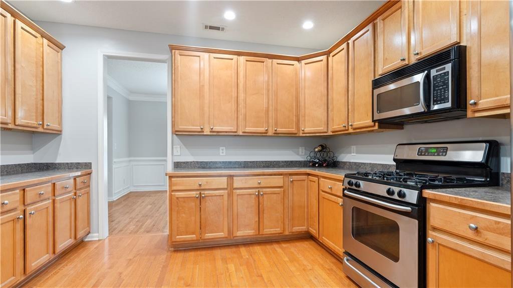91 Medallion Park Newnan, GA 30265 - Photo 12 of 45 a kitchen with stainless steel appliances granite countertop a stove a sink and a microwave