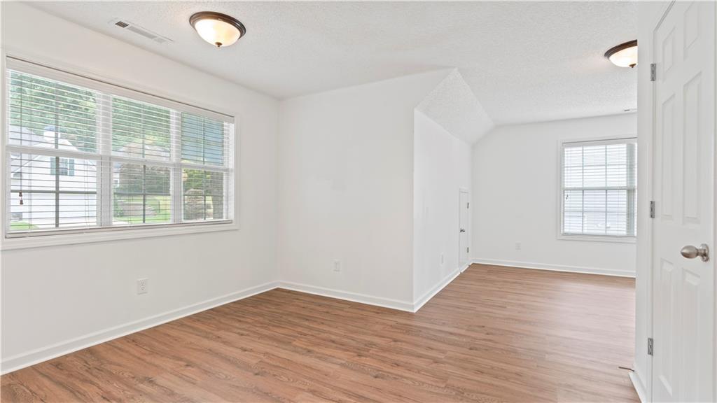 91 Medallion Park Newnan, GA 30265 - Photo 21 of 45 an empty room with wooden floor and windows