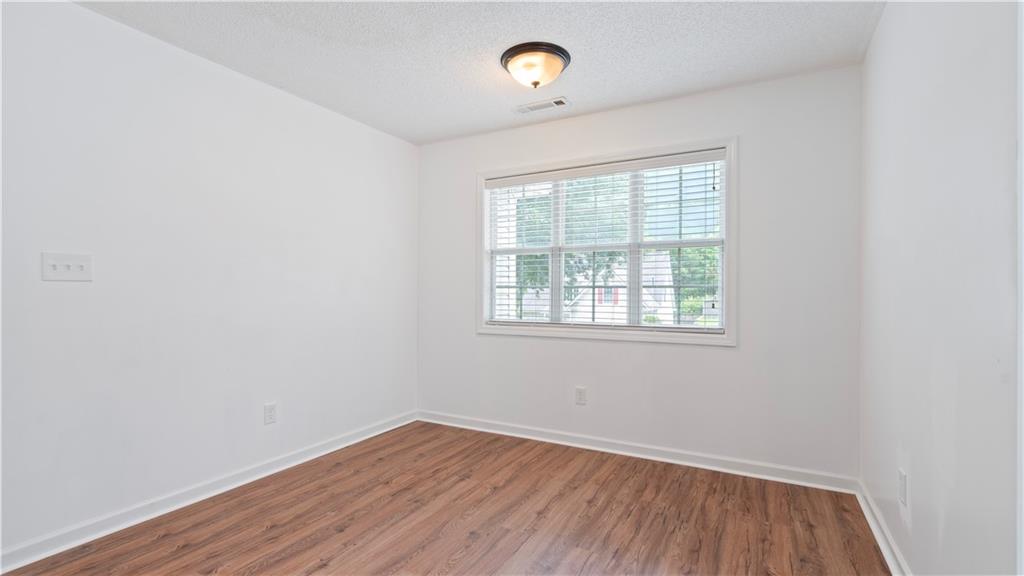91 Medallion Park Newnan, GA 30265 - Photo 23 of 45 an empty room with wooden floor and a window