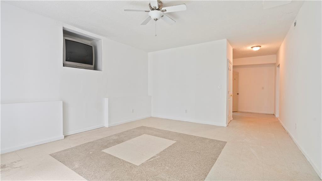 91 Medallion Park Newnan, GA 30265 - Photo 27 of 45 an empty room with a ceiling fan and a ceiling fan
