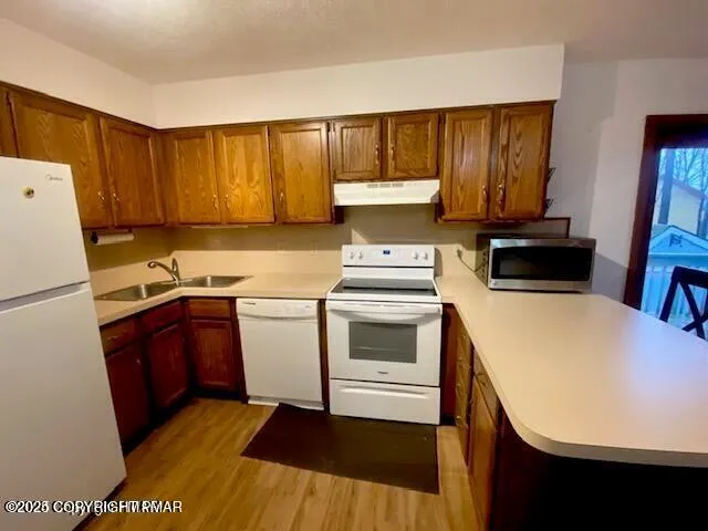 a kitchen with a refrigerator sink and stove