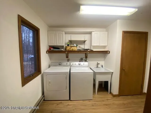 a view of storage and utility room with washer and dryer