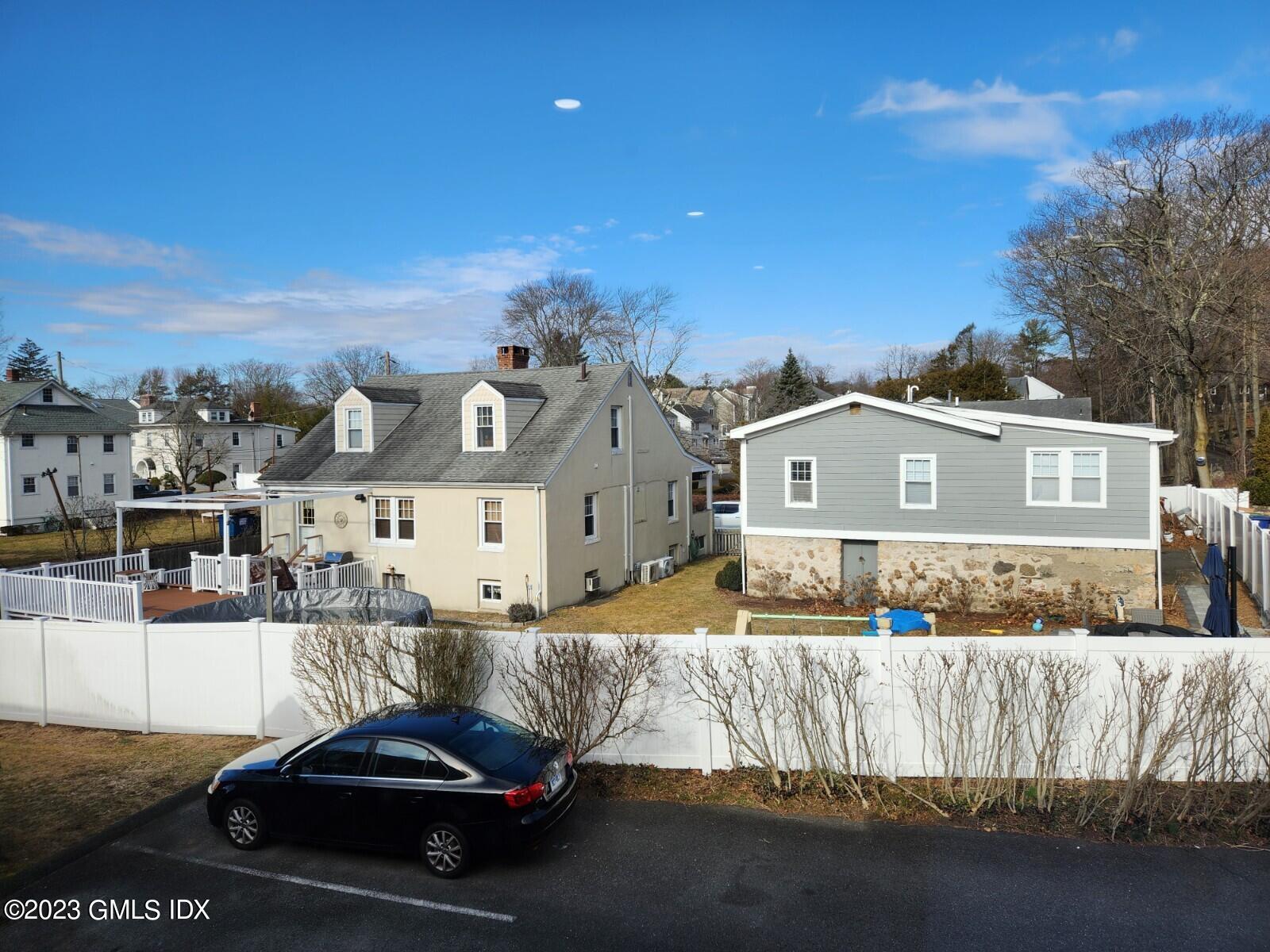96 Valley Road, Unit 18 Cos Cob, CT 06807 - Photo 13 of 24 a car parked in front of a white house
