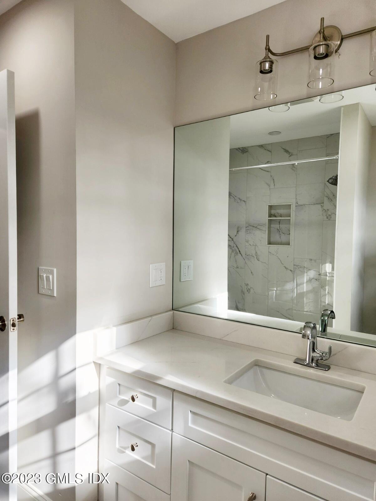 96 Valley Road, Unit 18 Cos Cob, CT 06807 - Photo 14 of 24 a bathroom with a sink and a mirror