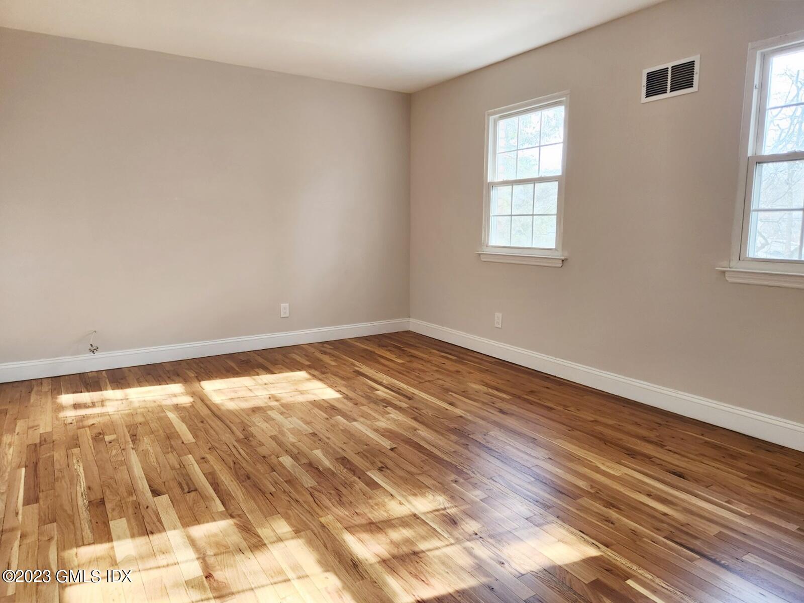 96 Valley Road, Unit 18 Cos Cob, CT 06807 - Photo 16 of 24 a view of empty room with wooden floor and fan