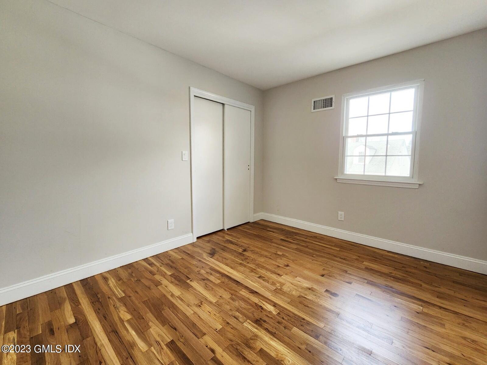 96 Valley Road, Unit 18 Cos Cob, CT 06807 - Photo 18 of 24 a view of empty room with wooden floor and fan