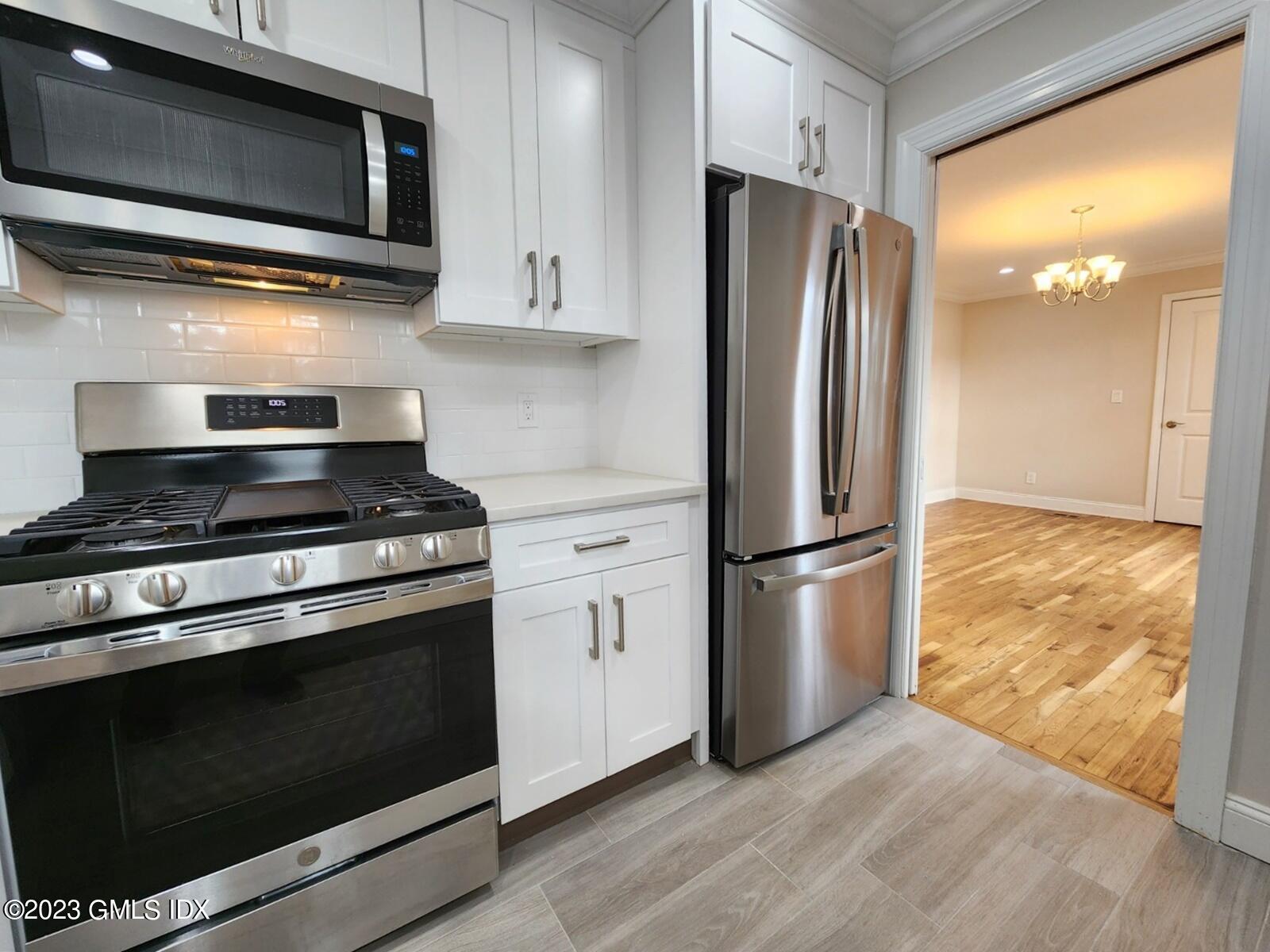 96 Valley Road, Unit 18 Cos Cob, CT 06807 - Photo 6 of 24 a kitchen with a stove microwave and refrigerator