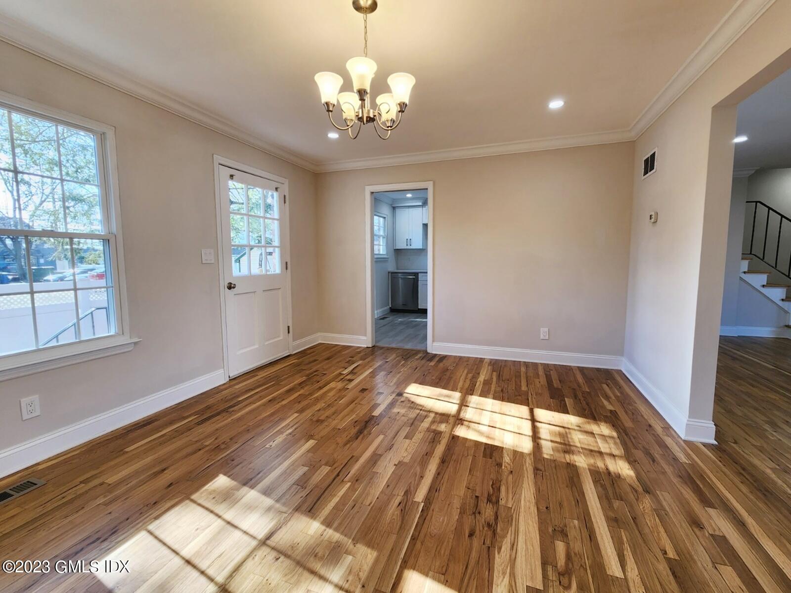 96 Valley Road, Unit 18 Cos Cob, CT 06807 - Photo 7 of 24 a view of an empty room with wooden floor and a window