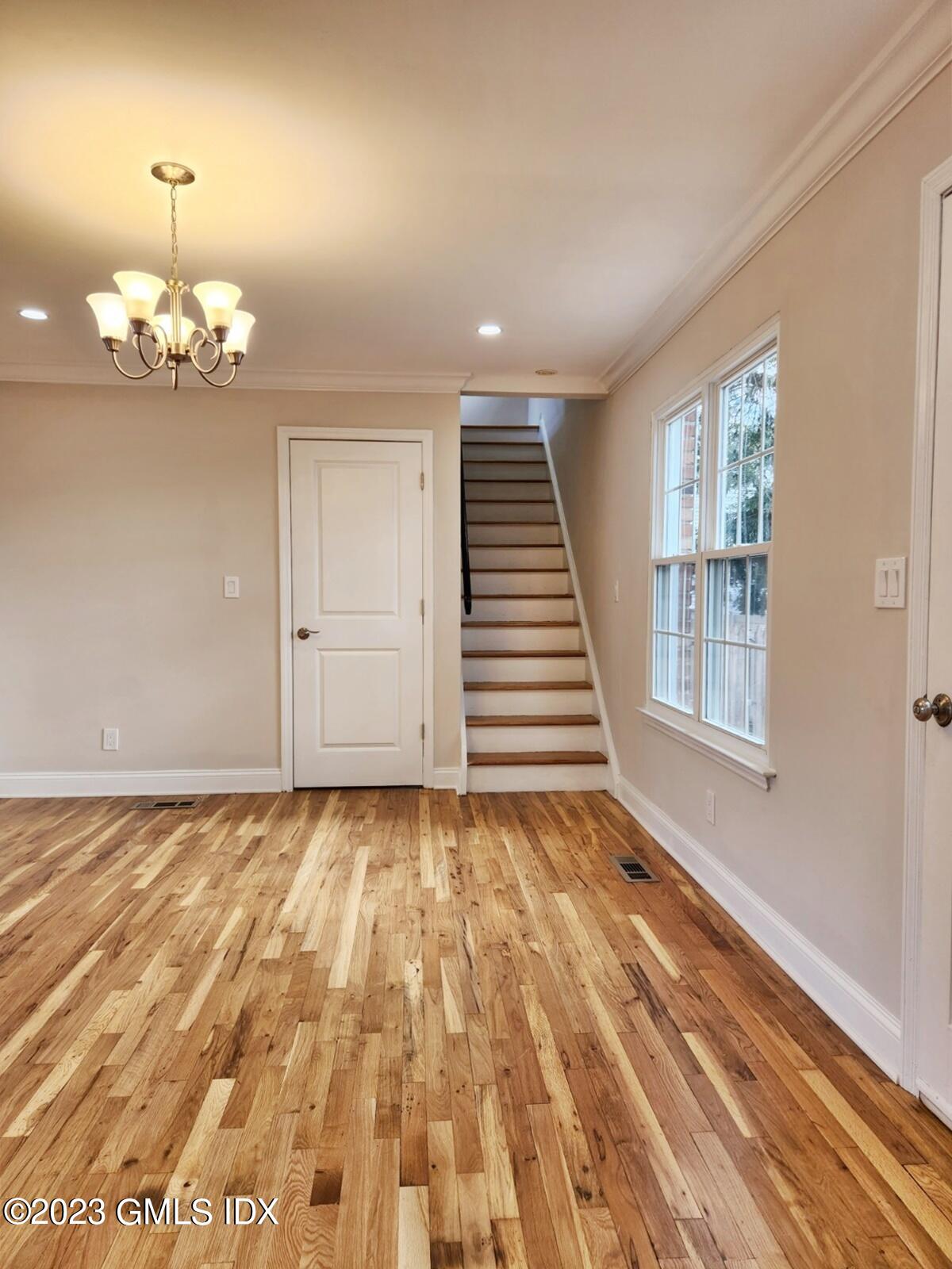 96 Valley Road, Unit 18 Cos Cob, CT 06807 - Photo 8 of 24 a view of an empty room with wooden floor and a window