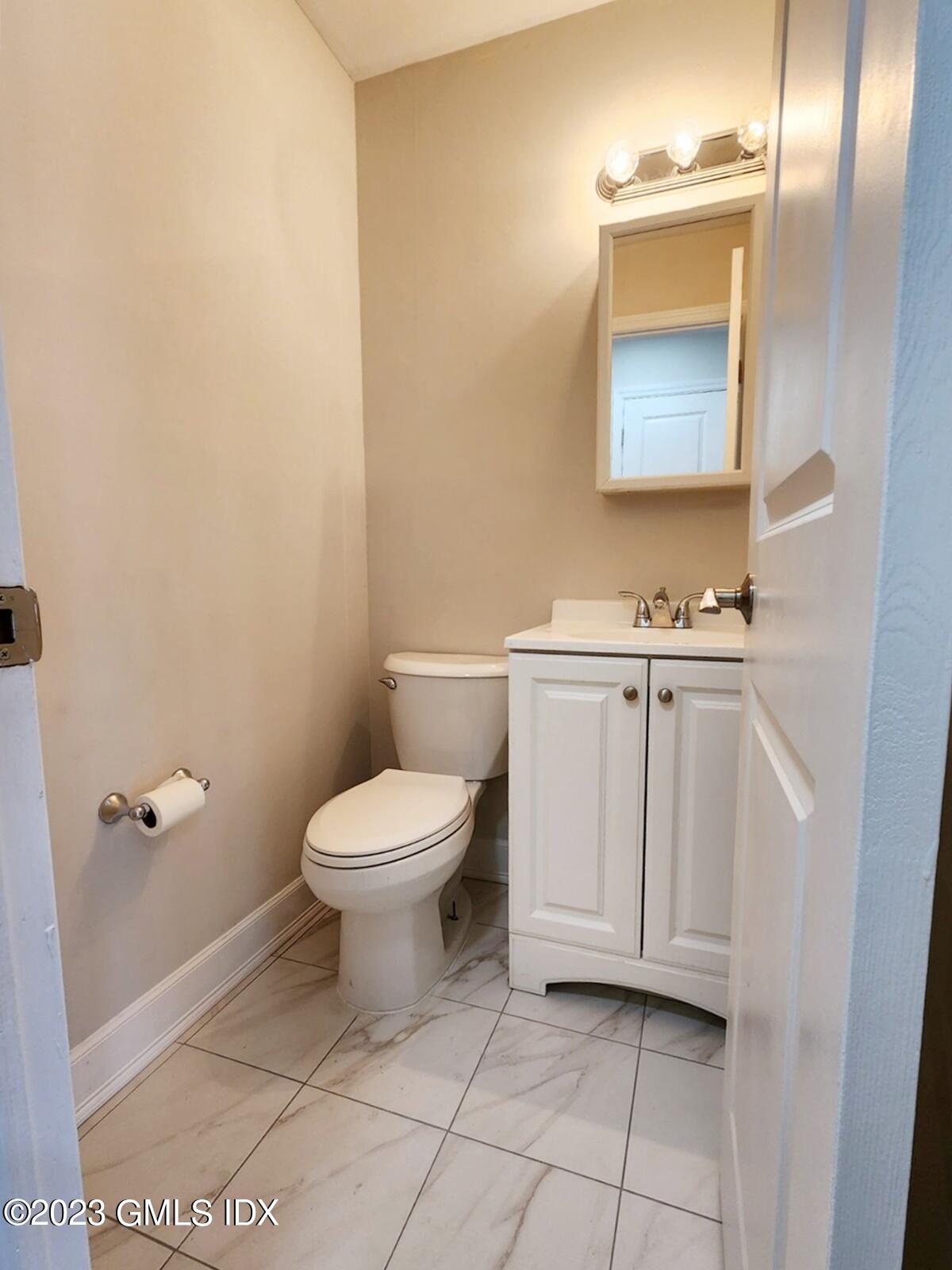 96 Valley Road, Unit 18 Cos Cob, CT 06807 - Photo 9 of 24 a bathroom with a toilet a sink and mirror