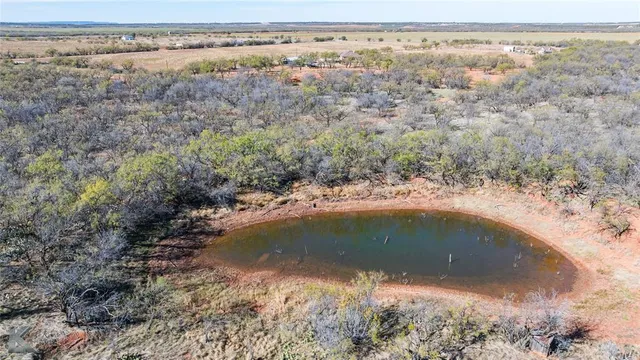 an aerial view of house with yard and mountain in the background