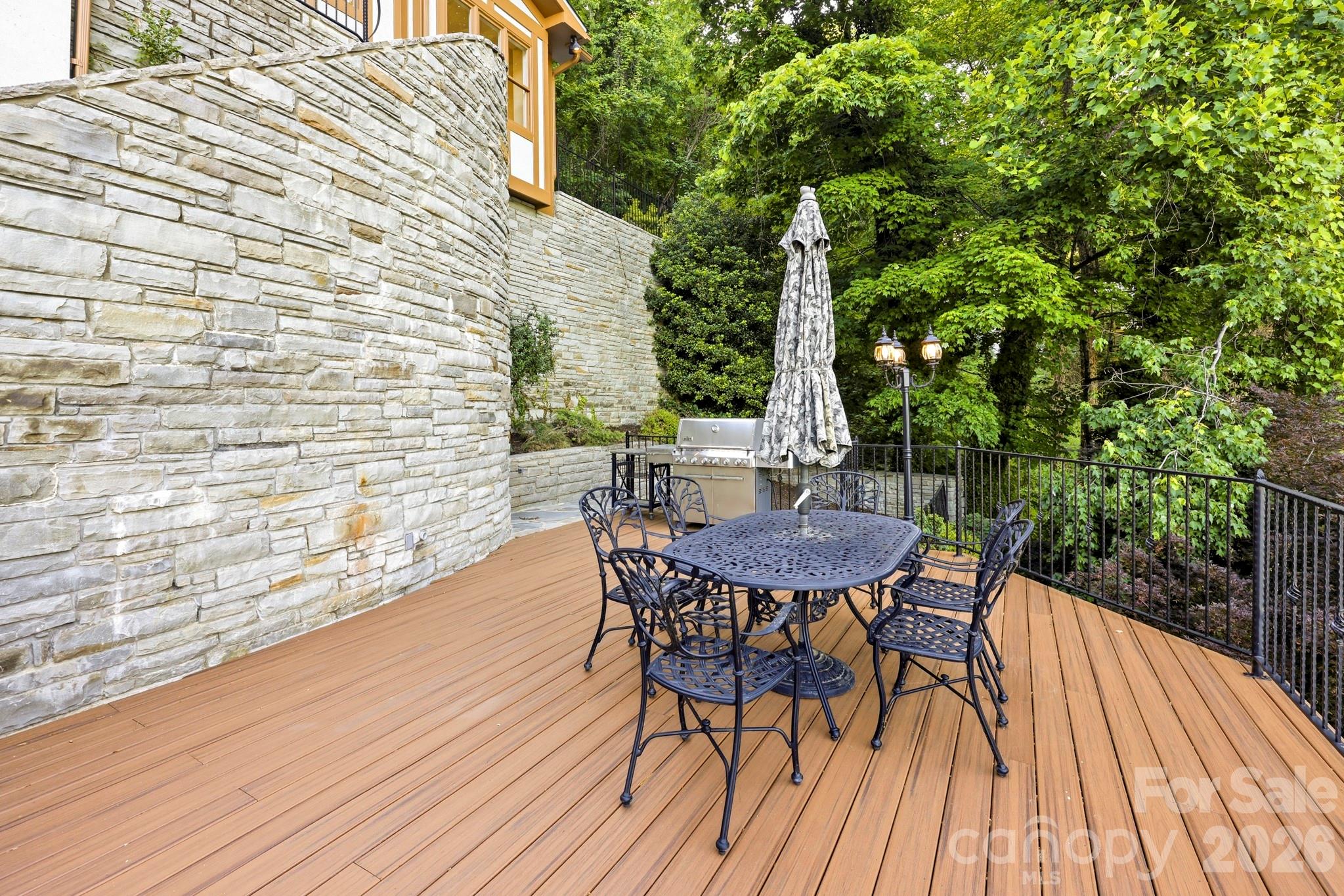 151 Garner Road Lake Lure, NC 28746 - Photo 34 of 48 a view of backyard with table and chairs and wooden floor