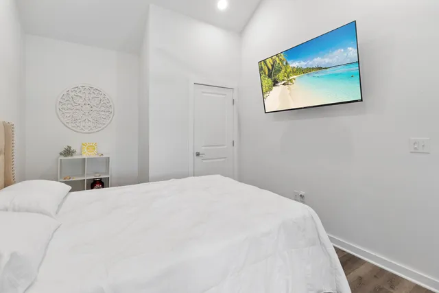 a bedroom with a bed and a wall painting