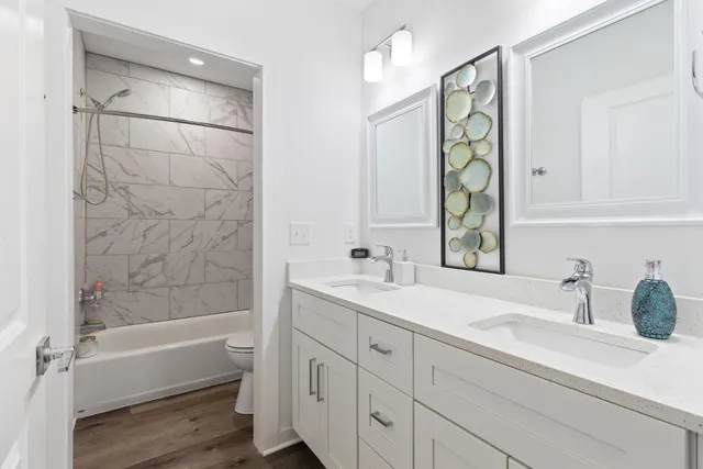 a bathroom with a shower sink and mirror