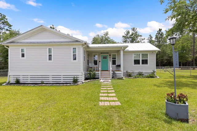 a view of a swimming pool with a lawn chairs under an umbrella