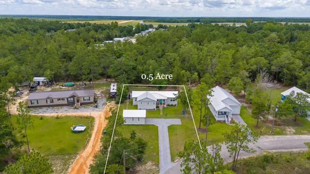 an aerial view of residential houses with outdoor space and swimming pool