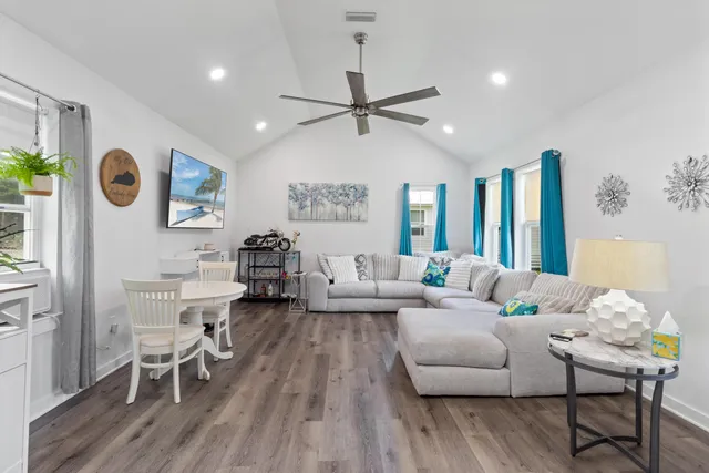 a living room with furniture and wooden floor