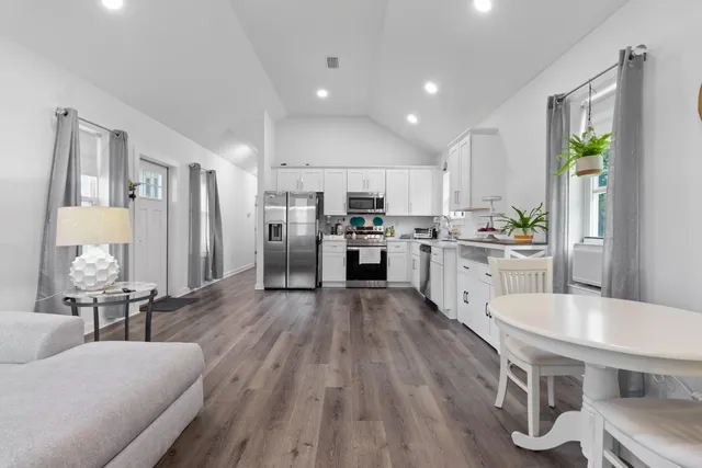 a large kitchen with a table and chairs