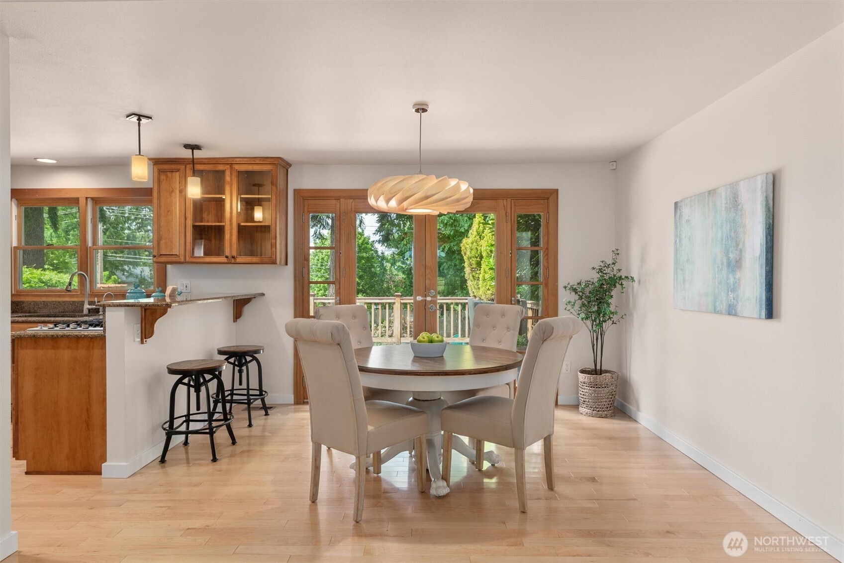 2101 233rd Street Southeast Bothell, WA 98021 - Photo 7 of 40 a dining room with furniture a chandelier and wooden floor