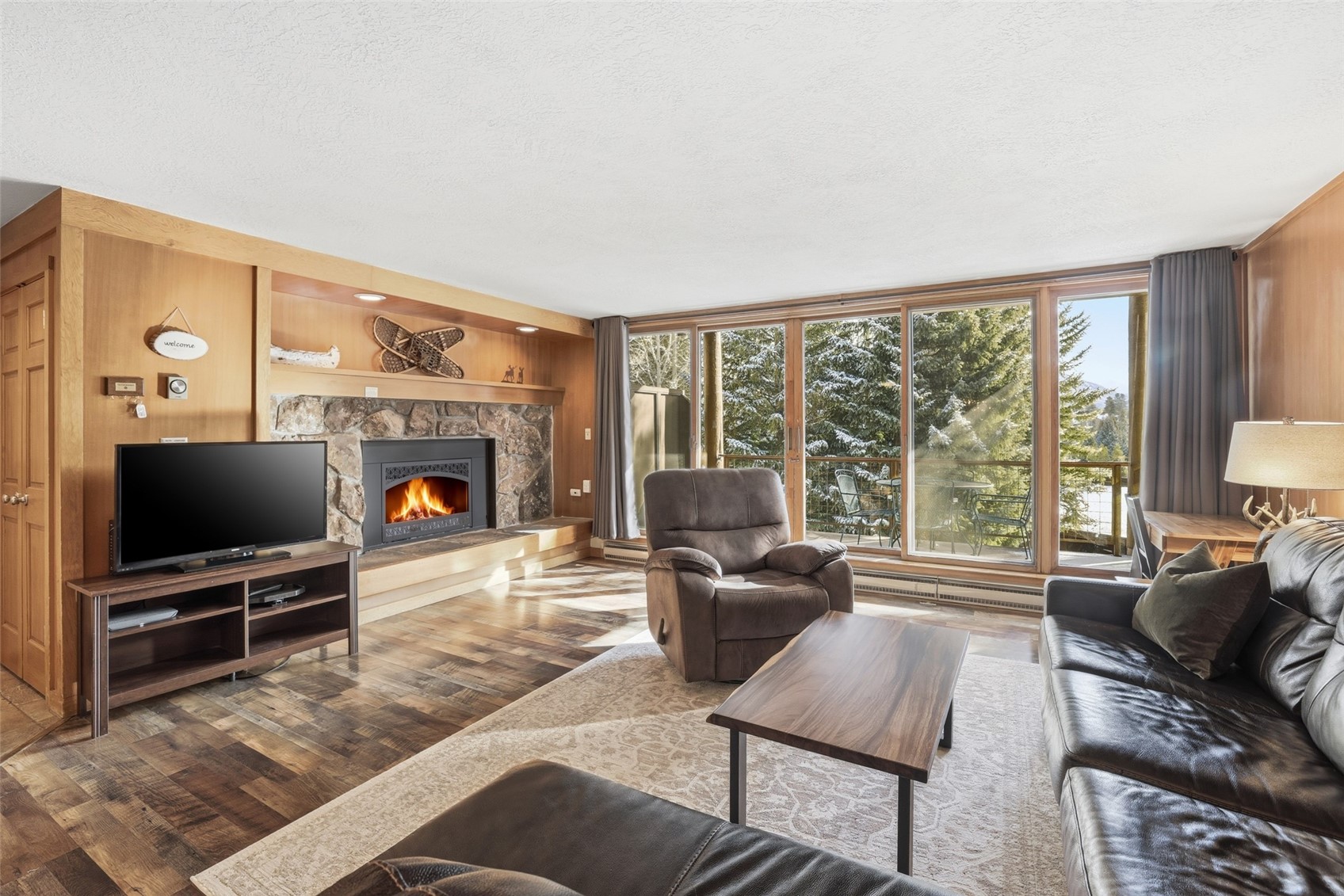 a living room with furniture a flat screen tv and a fireplace