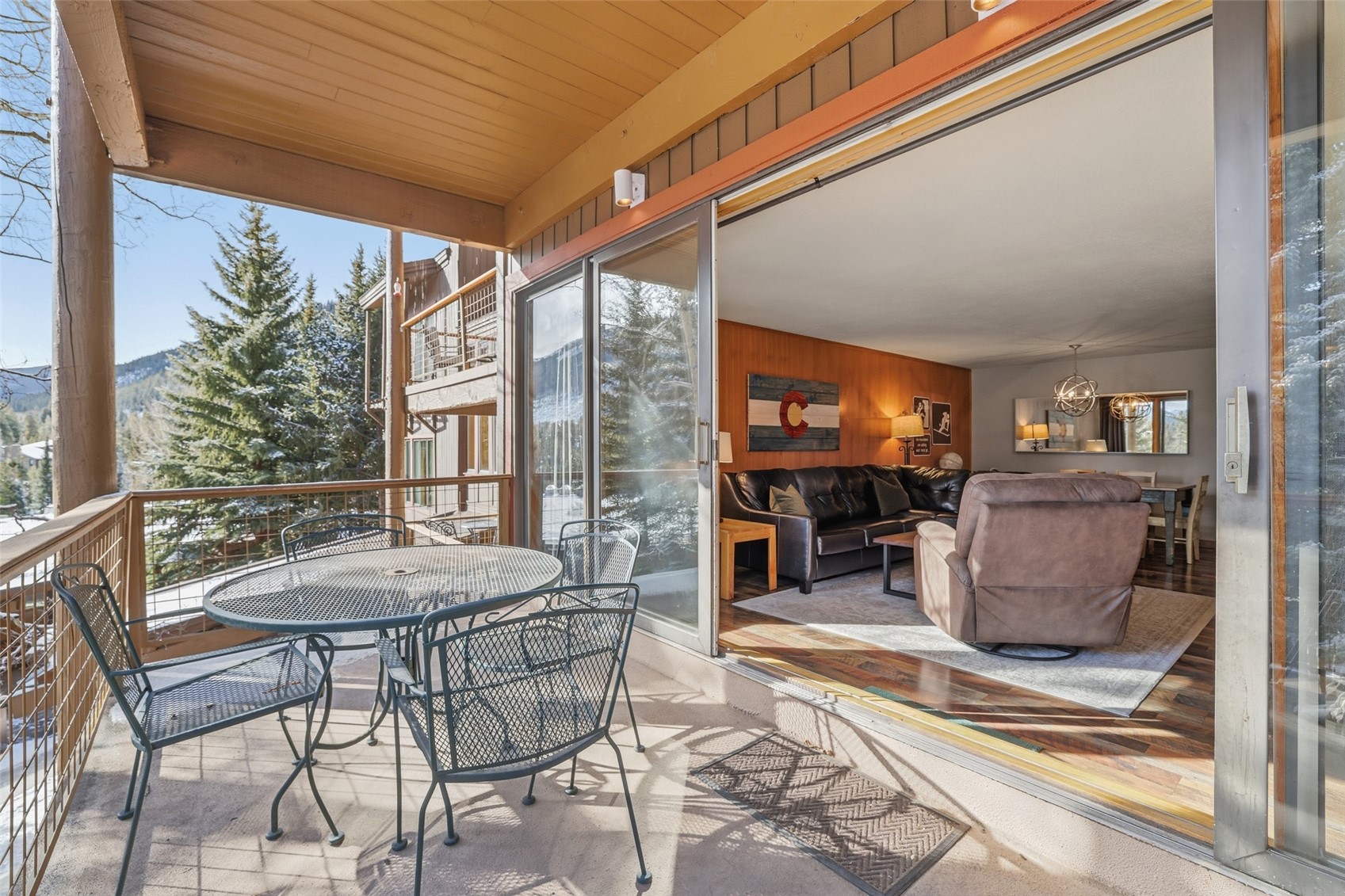 21700 Highway 6, Unit 2015 Keystone, CO 80435 - Photo 17 of 50 a view of a patio with table and chairs potted plants with wooden floor and seating space
