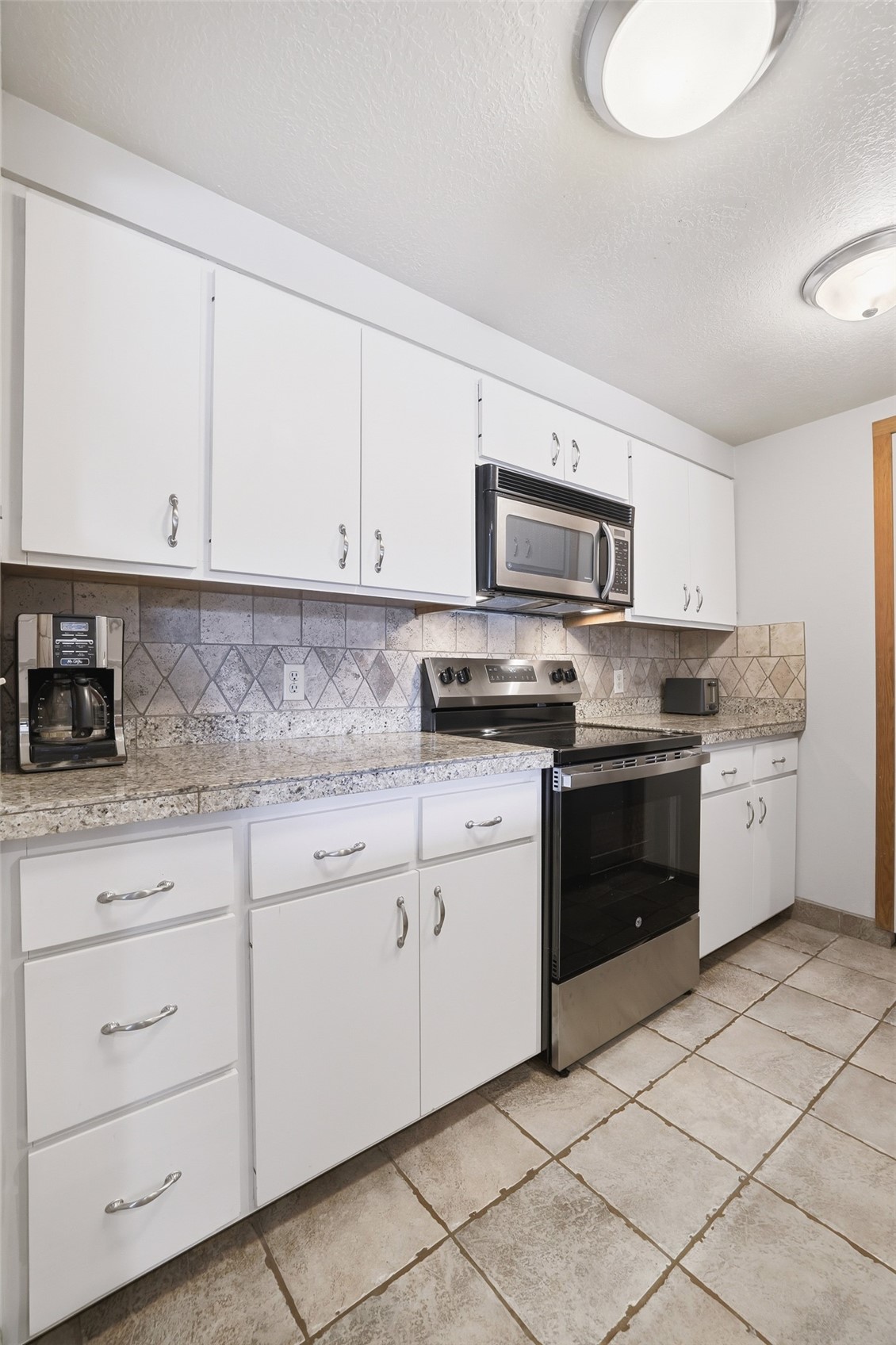 21700 Highway 6, Unit 2015 Keystone, CO 80435 - Photo 22 of 50 a kitchen with granite countertop white cabinets and stainless steel appliances