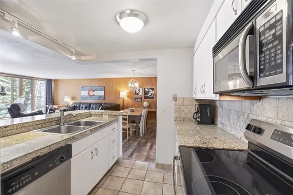 a kitchen with granite countertop a sink and stove
