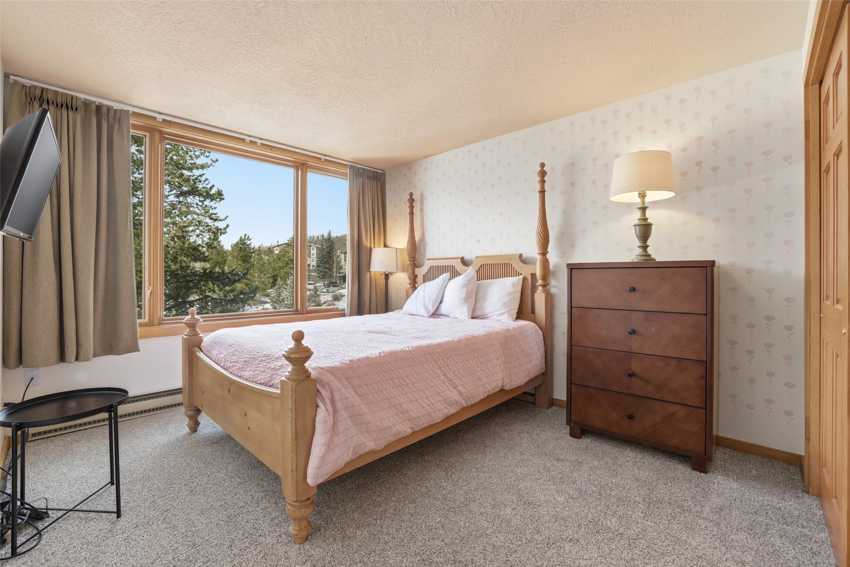 21700 Highway 6, Unit 2015 Keystone, CO 80435 - Photo 28 of 50 a spacious bedroom with a bed and a dresser next to a window