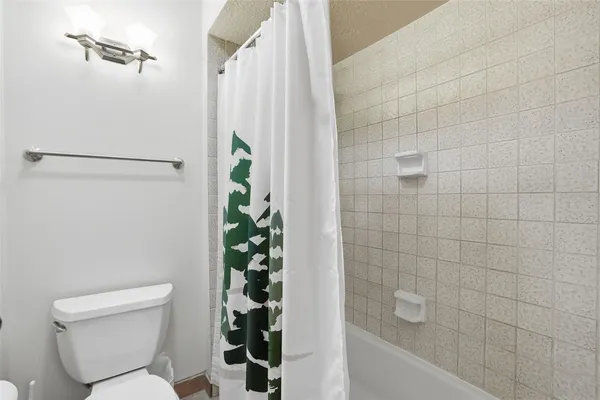 a bathroom with a toilet and shower