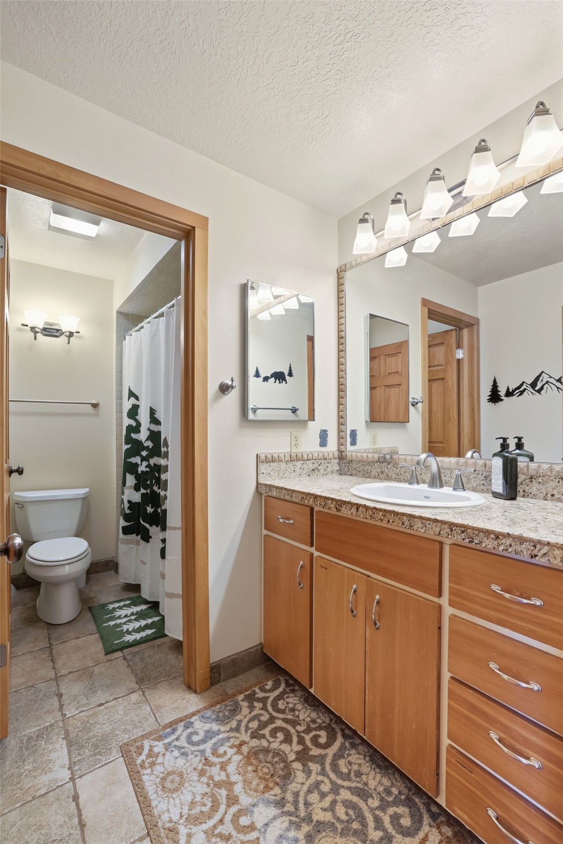 21700 Highway 6, Unit 2015 Keystone, CO 80435 - Photo 31 of 50 a bathroom with a granite countertop sink mirror and a toilet
