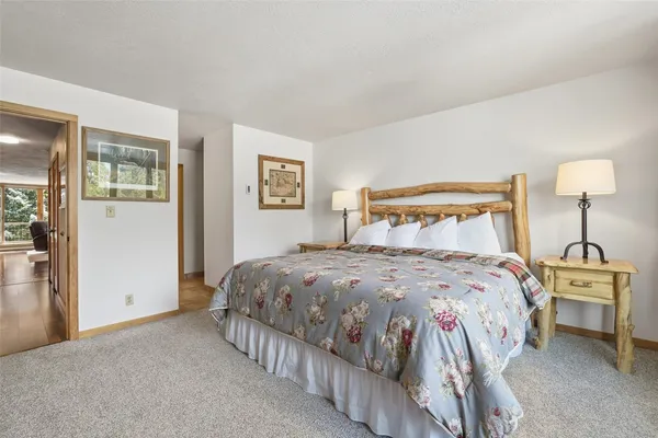 a bedroom with a bed and a lamp