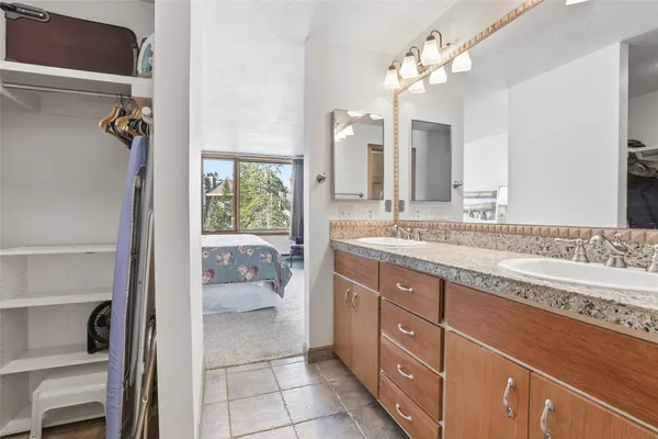 a spacious bathroom with a granite countertop sink a toilet and a mirror