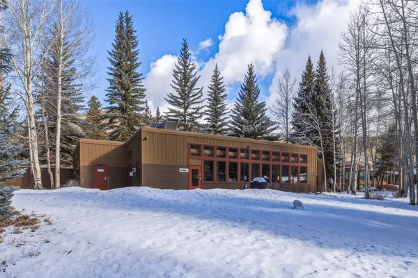 a view of a house with a yard and mountain view