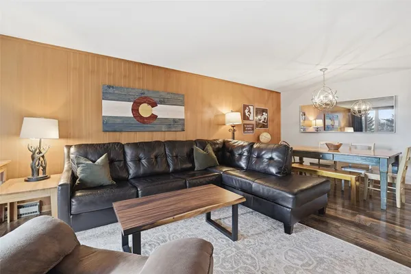 a living room with furniture and a lamp