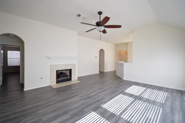 wooden floor in an empty room with a fireplace