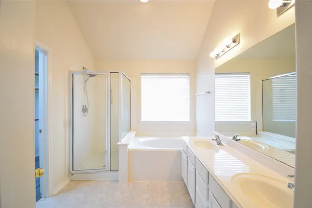 a bathroom with a granite countertop tub sink and mirror