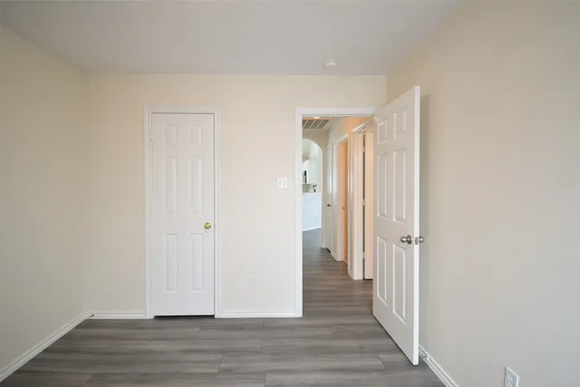 a view of a hallway with wooden floor