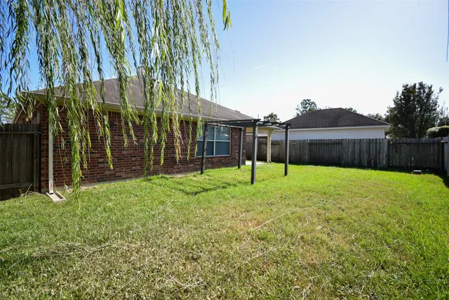 a view of a house with a backyard and a garden
