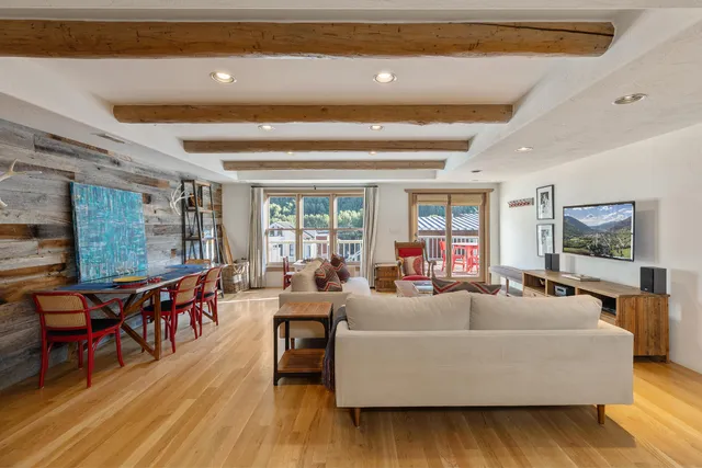 a living room with furniture a pool table and a flat screen tv