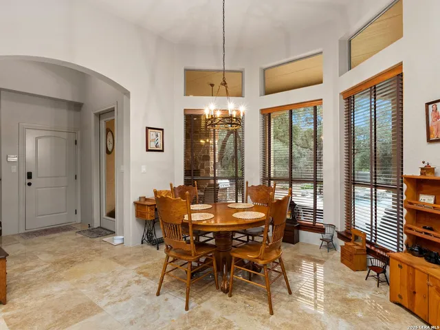 a living room with furniture a chandelier and a fireplace